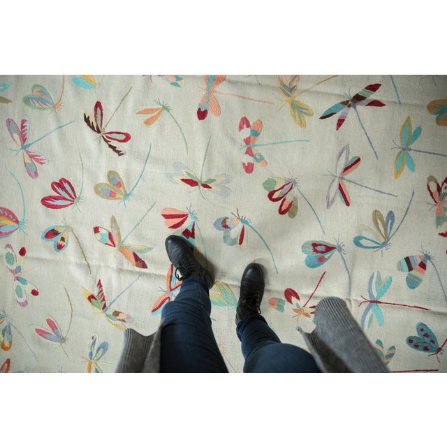 :: Plain woven Kilim with covered array, replete in coloration, of dragonflies in random views. Colors and shades include:...