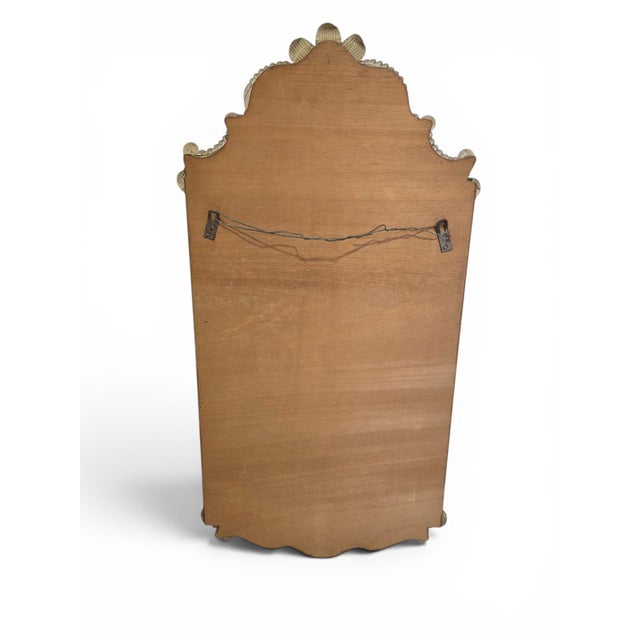An elegant Venetian-style wall mirror, distinguished by its elaborate cut, engraved, and layered glass frame, executed in...