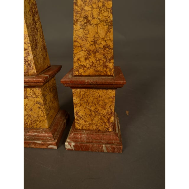 Pair of 19th-century Italian marble obelisks dating to circa 1890, crafted in terracotta and caramel-toned marble. Each...
