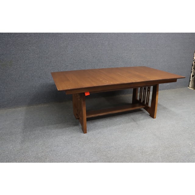 Quality dining table by Stickley from the Highlands collection. Crafted in solid wood with a warm finish, featuring a...