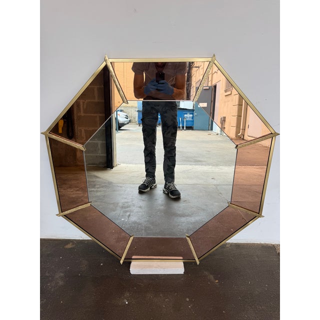 This elegant mirror is a masterclass in texture and warmth, featuring a sophisticated interplay of materials. The frame is...