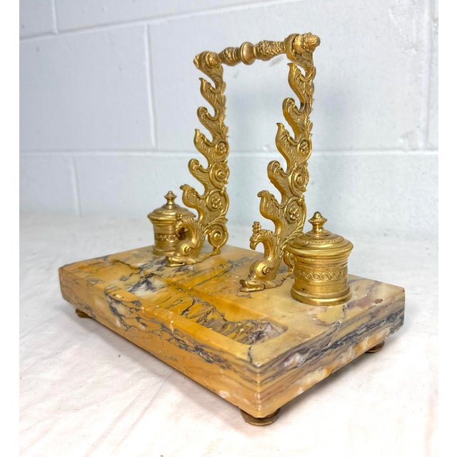 This Antique 19th century French desk inkwell features a solid siena marble base and exquisitely cast dual dolphins that...