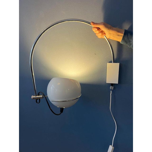 Vintage space age arc wall lamp by GEPO. The design allows you to place the shade in the ring in any direction desirable....