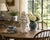 An elegant mid-20th century white glazed ceramic fruit topiary featuring an abundant arrangement of sculpted fruit...