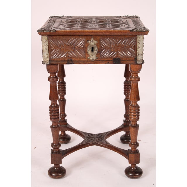 Spanish baroque style oak box, 19th century resting on a circa 1930's oak stand. The hinged box with a carved top and tole...