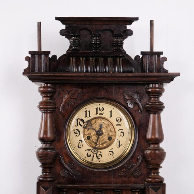 Antique wall clock manufactured by junghans in the 1920s. The clock is made of dark walnut with a classic wooden case and...