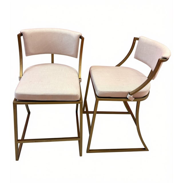 Pair of Ballard Designs Allister counter stools featuring sculptural metal frames in a matte antique brass finish with...