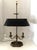 An exquisite Bouillotte lamp by Frederick Cooper, circa 1970s. Features a brass frame with two candlestick lights over an...