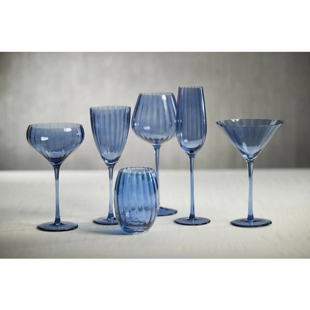 Crafted of beautifully textured glass, the colored glass set features a streamlined design with a pop of color. Raise a...