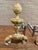 Attractive pair of brass andirons with an artichoke finial and decorative detailing. 9.75”W x 21”D x 15.5”H
