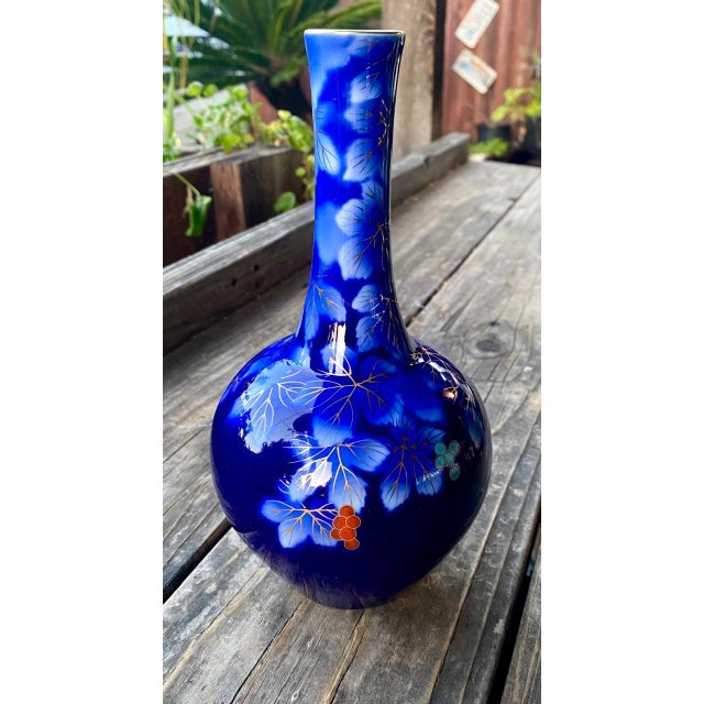 A beautiful vintage Fukagawa porcelain vase from Arita, Japan, showcasing the maker's celebrated cobalt blue glaze adorned...