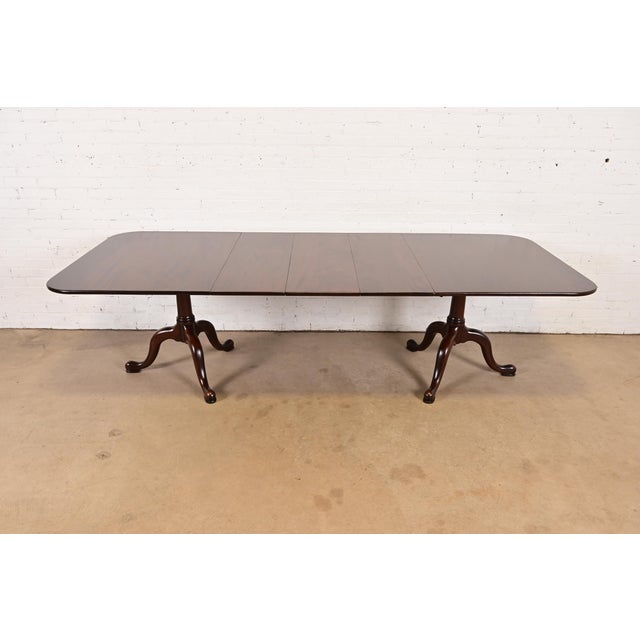 An exceptional Georgian or Regency style double pedestal extension dining table By Henkel Harris USA, 1971 Measures: 66"W...