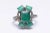 A large center emerald-cut emerald ring flanked with 4 smaller emeralds on the corners. Pave`-set, round faceted diamonds...