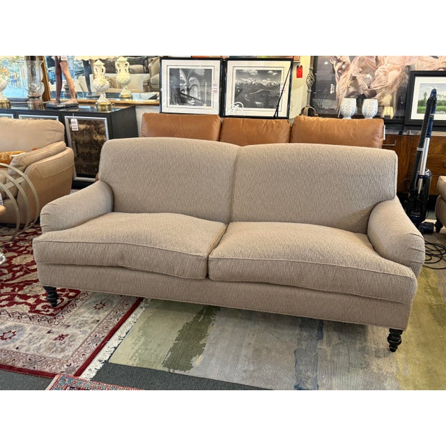 Design Plus Gallery presents a Rolled Arm Sofa on Casters from J. Fitzgerald. The sofa has a soft tan upholstery with...