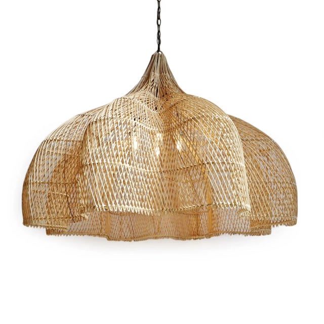 Medium raw wicker Matador ruffle shaped chandelier. Impressive hand crafted piece with organic shape and material. Four...