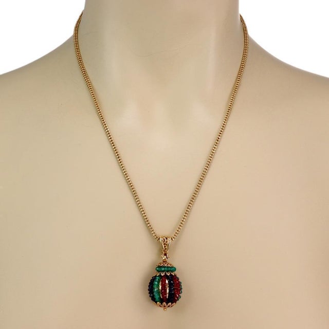 This is a beautiful pendant and chain, crafted from 14k yellow gold, the pendant features a gold ball covered with strands...