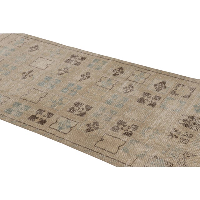 This vintage runner rug is a 3x6 Turkish distressed piece, made with hand-knotted wool circa mid-20th century. It is an...