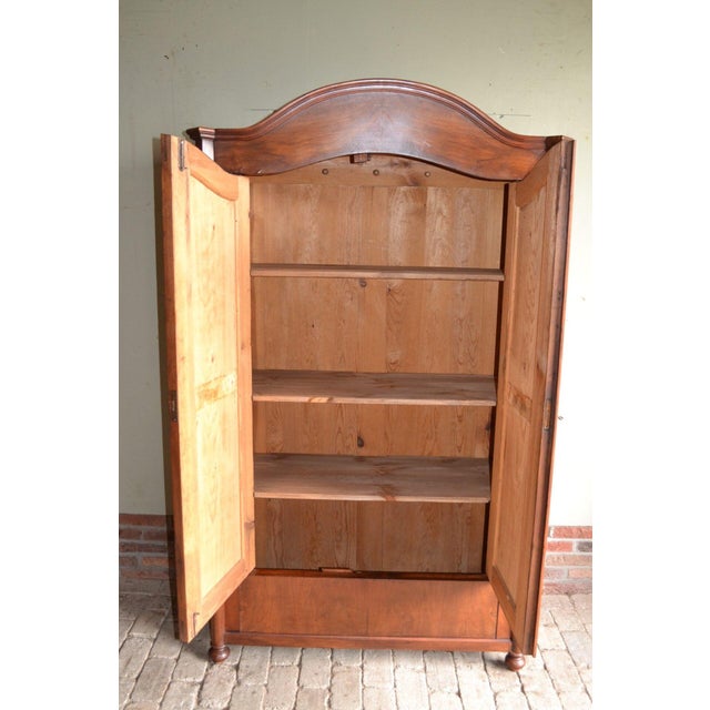 19th century German mahogany arch cupboard. The dimensions are 189x113x49. Height-adjustable shelves behind the two doors....