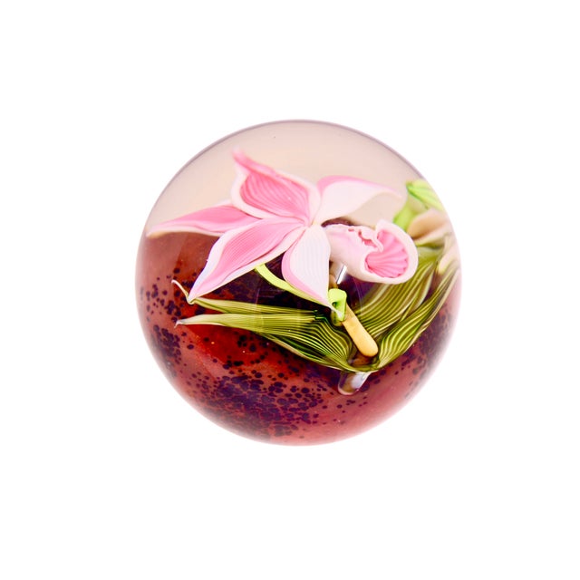 Vintage hand blown art glass sphere paperweight highlighting an intricate orchid in pink raspberry burgundy celadon green....