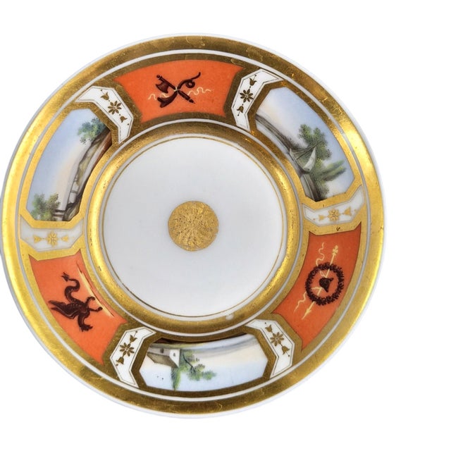 An unusual French Old Paris porcelain coffee cup and saucer, made circa 1820. The gently tapered cup has a gilt interior...