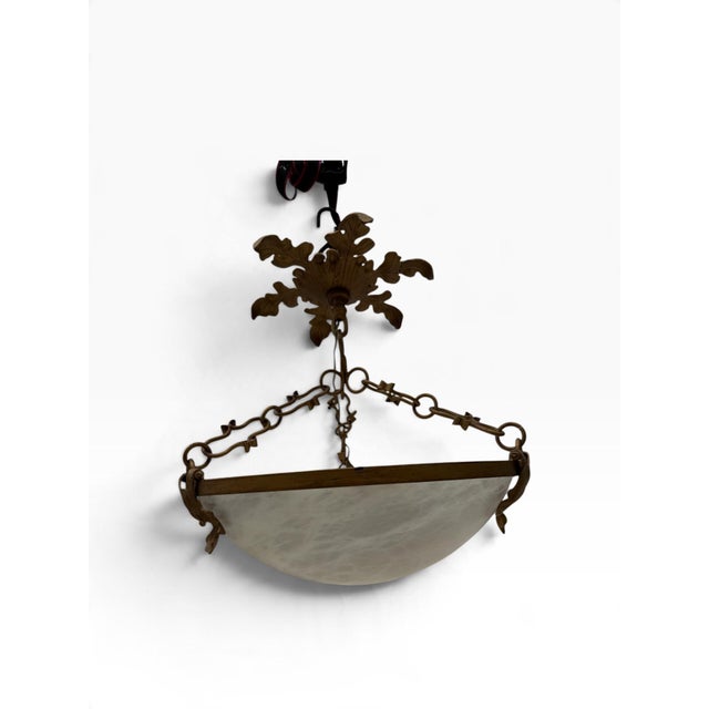A striking French Empire style inverted pendant chandelier featuring a beautifully hand-carved, genuine white alabaster...
