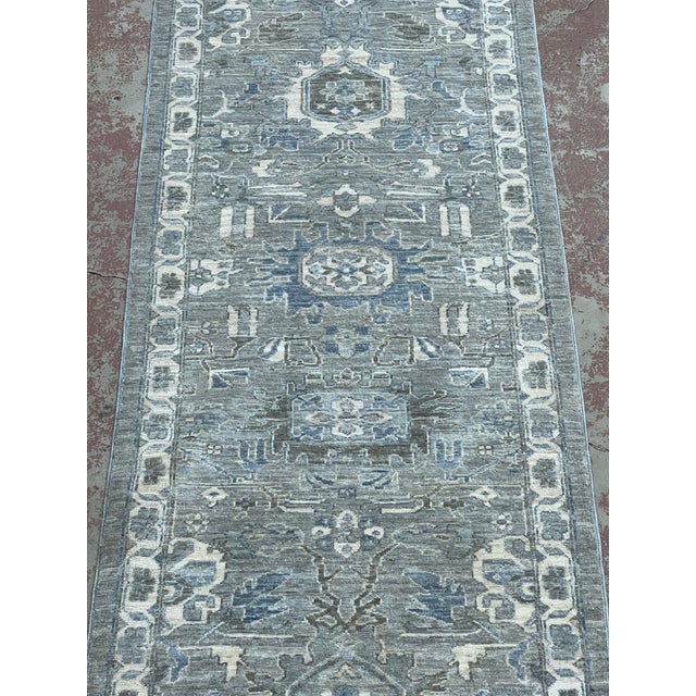 Afghan Khotan runner, hand-knotted in Afghanistan from 100% wool. Measuring 2’6” x 11’6”, the runner features a...