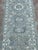 Afghan Khotan runner, hand-knotted in Afghanistan from 100% wool. Measuring 2’6” x 11’6”, the runner features a...