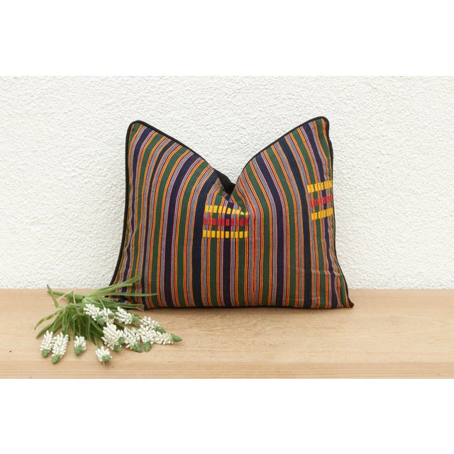Add a pop of color and history to your home with a touch of African artistry with this captivating vintage kente pillow....